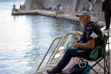 old man fishing by the sea