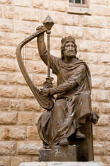 Bronze statue of King David playing the harp outside his tomb in the Old City of Jerusalem, Israel.