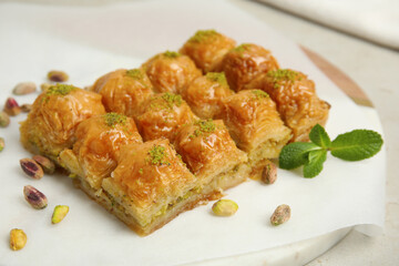 Delicious sweet baklava with pistachios and mint on board, closeup