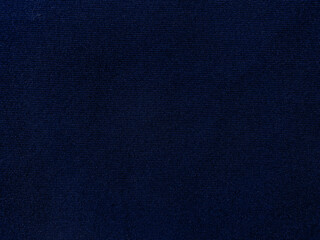 Dark blue velvet fabric texture used as background. Empty dark blue fabric background of soft and smooth textile material. There is space for text..