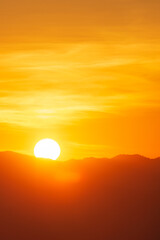 Closeup to sun over the mountain hill at sunrise time or morning time.