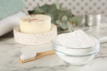 Obraz na płótnie Canvas Tooth powder, brush and soap on white marble table, closeup