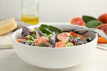 Bowl of delicious sicilian orange salad on white wooden table, closeup