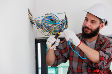 Hispanic male Electrician engineer installer with a tool in his hands. Maintenance service Repair...