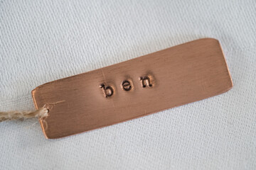 Ben identity engraved name dog tag copper metal name plate badge. Shiny and clean stamped letters...