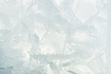 The texture of the frozen water surface. Ice covered with cracks close-up