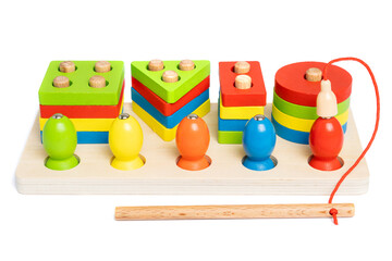Wooden sorter made of colored geometric puzzles and shapes with magnets to simulate fishing. A toy...