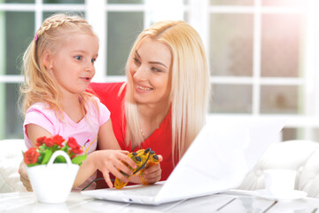 mother and daughter using laptop