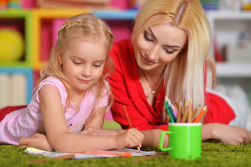 Fototapeta premium Beautiful mother and daughter drawing with her little girl