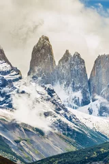 Poster Torres del Paine peaks coming from clouds © Fyle