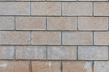 Fototapeta premium The antique wall is paved with gray stones, top view. stone texture, outdoor stone tiles