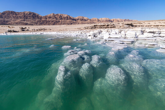 View of the salt formations protruding from the waters of the Dead Sea.