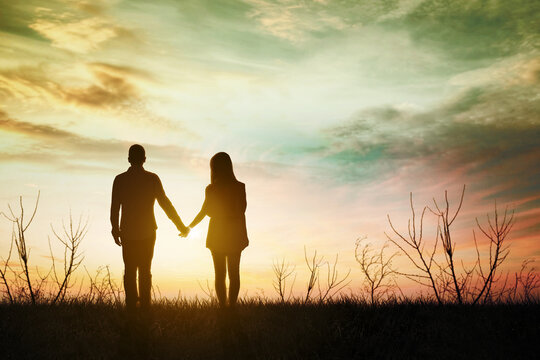 Young couple holding hands together at park