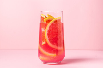 Pink cocktail with grapefruit on a pink background. Sweet fruit cocktail. delicious drink