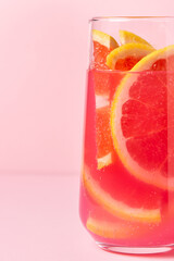 Pink cocktail with grapefruit on a pink background. Sweet fruit cocktail. delicious drink