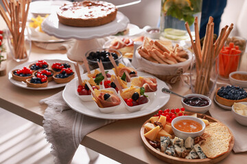 Dishes with different food on table indoors. Luxury brunch