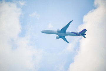 Fototapeta na wymiar Close-up aircraft flying against cloudy sky.