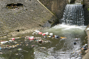 A river that looks dirty and polluted with garbage and waste.