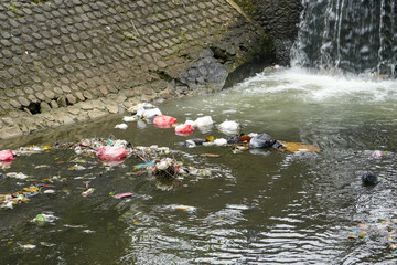 A river that looks dirty and polluted with garbage and waste.