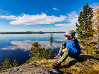 A little boy on the White Sea coast on a sunny day. Karelia. Russia. SEPTEMBER 2021