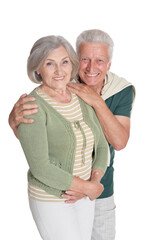 Portrait of happy senior couple embracing on white background