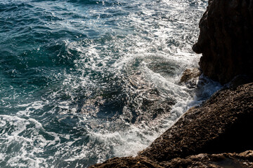 Waves splashing at rocks at the beach