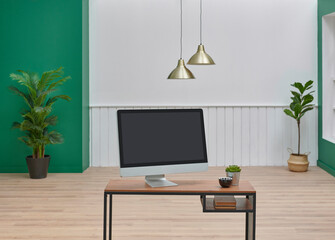 Close up wooden desk and computer style, lamp and white wall background interior room design.