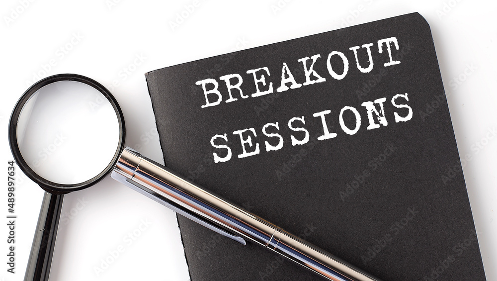 Poster breakout sessions - business concept, magnifier with white text message on black notebook