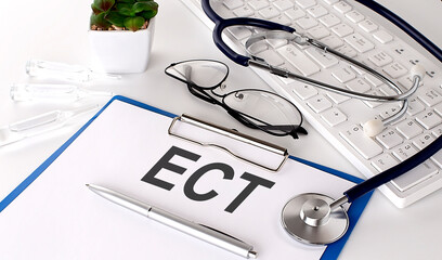 ECT text on white paper on white background. stethoscope ,glasses and keyboard