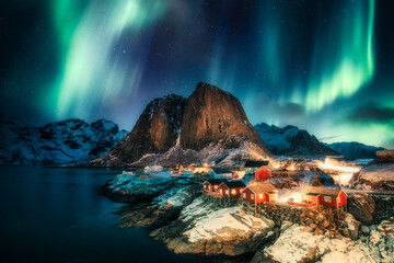 Aurora borealis, Northern lights over mountain with fishing village on coastline at Hamnoy, Lofoten islands - obrazy, fototapety, plakaty