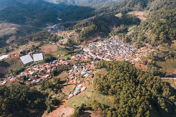 Fototapeta na wymiar Aerial view of local rural village in the valley on faraway at countryside among the tropical rainforest