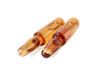 Brown pharmaceutical ampoules with medication on white background