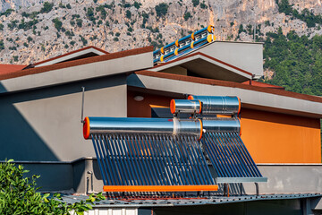 solar thermal collectors installed on the roof of a residential building © Evgeny