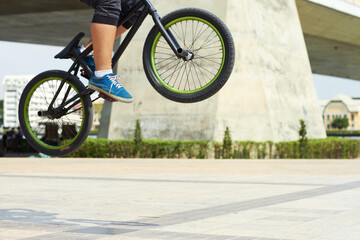 Hell risk to fall just to fly. A BMX rider doing tricks out in the city.