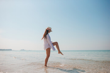 Fototapeta na wymiar Woman on the beach enjoying summer holidays