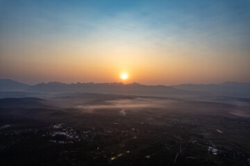 aerial view 4K Time lapse of Majestic sunset or sunrise landscape Amazing light of nature cloudscape sky and Clouds moving away rolling with mountain in thailand and earth day concept