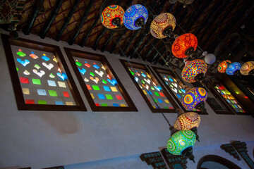 Doha,Qatar-May 05 2019: In the Old market Souk Waqif a decorative, traditional, glass mosaic lamps hanging. 
