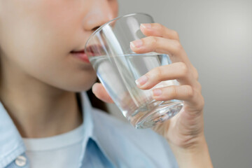 Happy beautiful, asian young woman, girl drinking, sip fresh glass of water for hydration of body,...