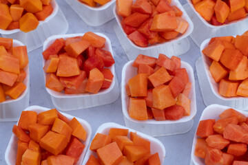 Slices of Papaya fruit - served on small white plates are a popular steet food of local people pf...