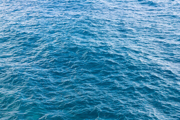 Blue water surface with small waves at sea