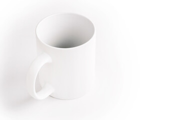 White ceramic cup on white background.