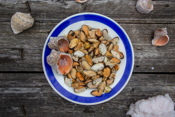 peeled mussels on a vintage plate with a blue border