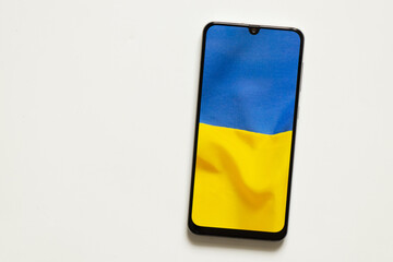 The national flag of Ukraine as a background on the phone, peace in Ukraine, no war, free