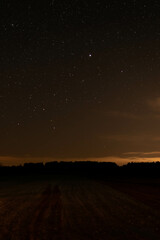 night starry sky over the forest, sky seen from Poland in February, starry sky and black landscape outline