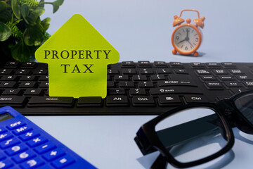 Property tax text on yellow paper on a desk. Real estate property concept.