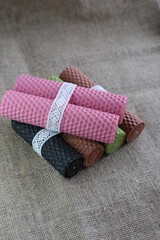 Handmade eco beeswax candles gift box on rustic background. Natural colourful candles.