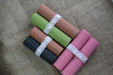 Handmade eco beeswax candles gift box on rustic background. Natural colourful candles.