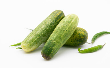 cucumber with green chili over on white background.