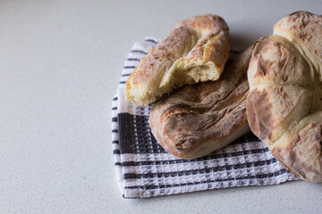 Homemade bread on a white-blue towel. Bakery. Fresh, aromatic, hot bread. The concept of making bread at home.