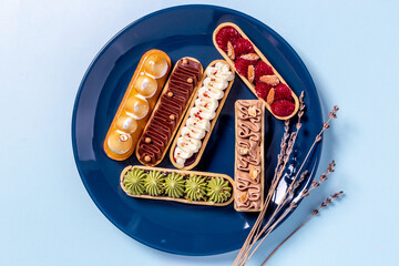 Eclairs with pistachio raspberries and chocolate cream topping